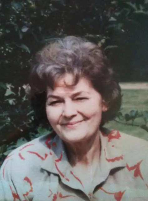 A woman with short hair is smiling for the camera.