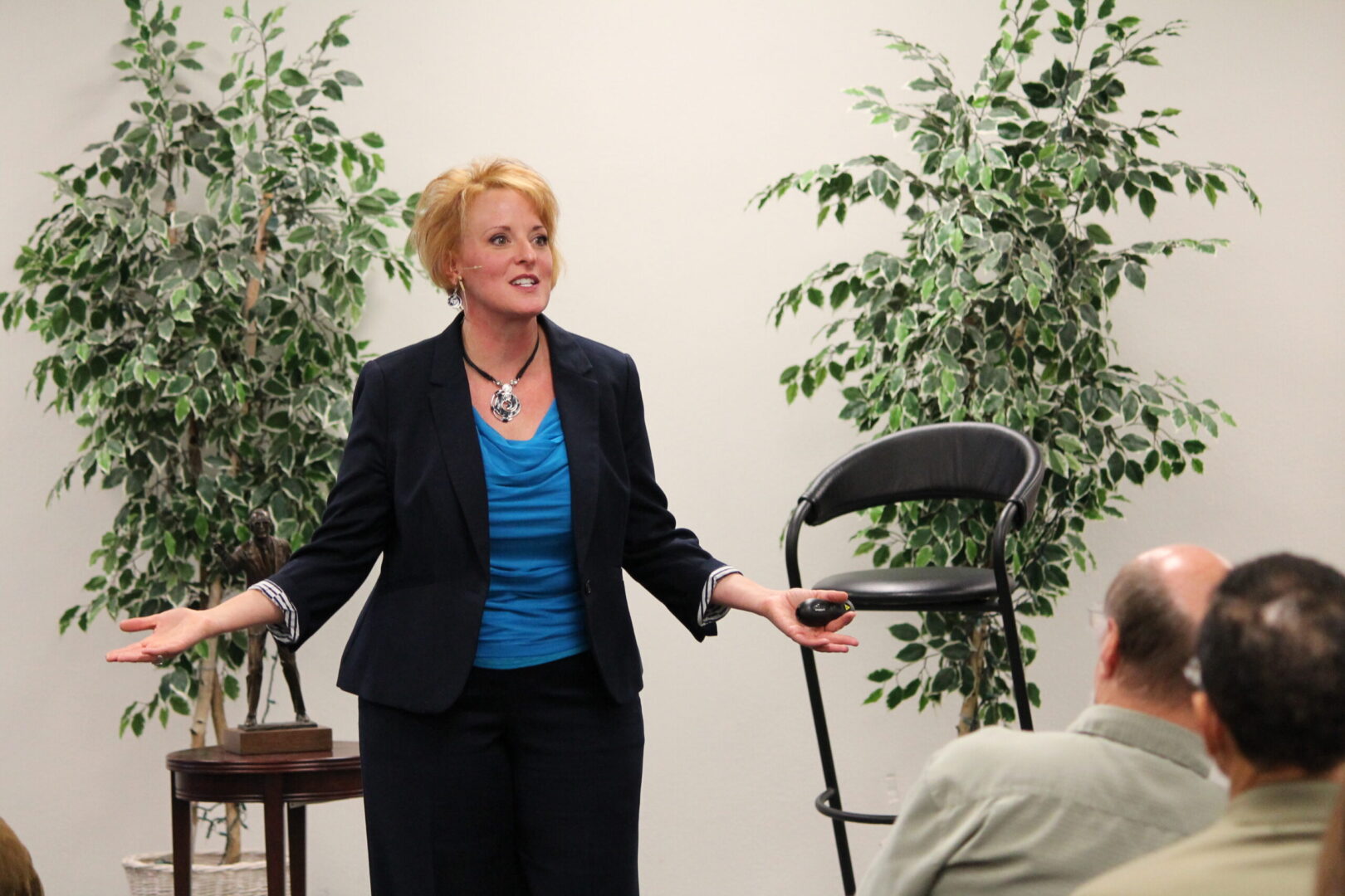 A woman standing in front of two men.