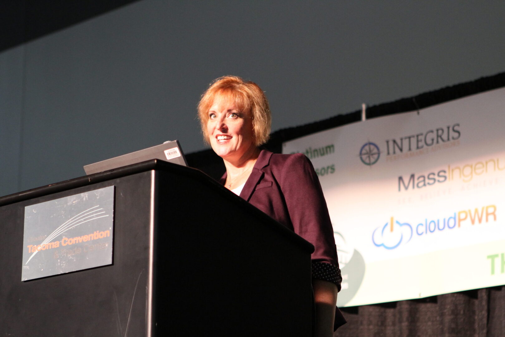 A woman standing at the top of a podium.